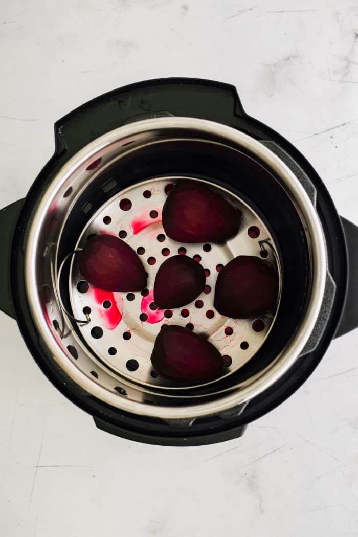 Instant Pot with five medium-sized cooked red beets.