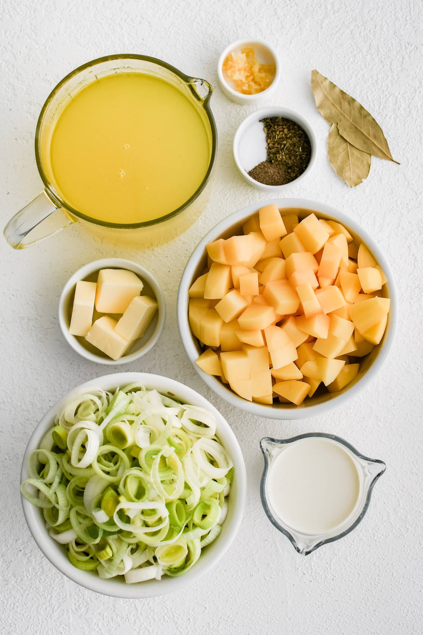 All of the ingredients needed to make Potato Leek Soup recipe in individual measuring cups and ramekins.