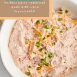 Overhead photo of a bowl filled with creamy TikTok boat dip (pool dip), topped with shredded Colby Jack cheese and sliced green onions. Text overlay reads Quick + Easy Pool Dip Perfect Party Appetizer Made with Just 6 Ingredients.