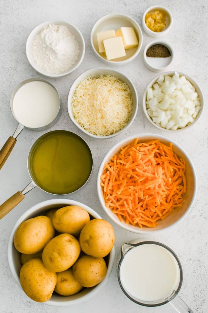 All of the ingredients needed to make a cheesy scalloped potatoes in individual measuring cups and ramekins.