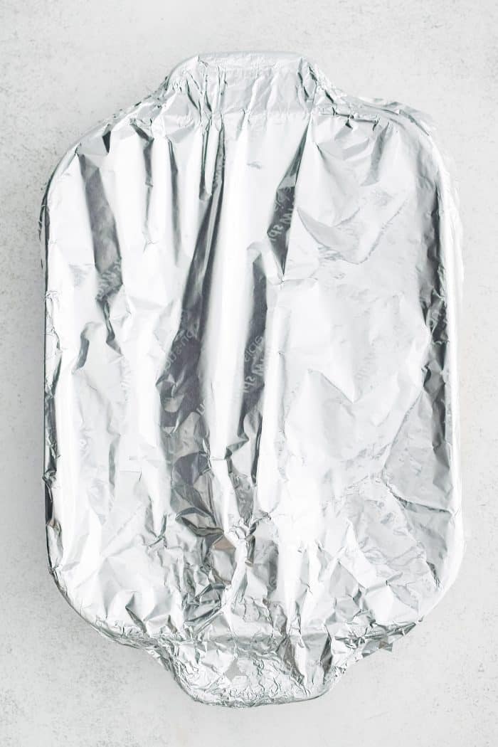 Large 9x13-inch baking dish covered with aluminum foil.