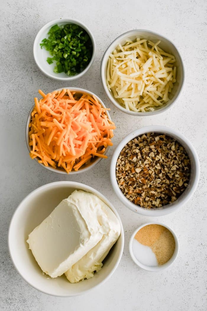 All of the ingredients needed to make a classic cheese ball in individual measuring cups and ramekins.