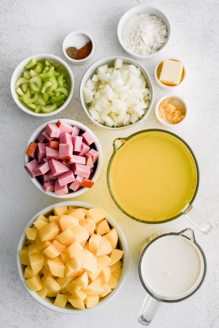 All of the ingredients needed to make a ham and potato soup in individual measuring cups and ramekins.