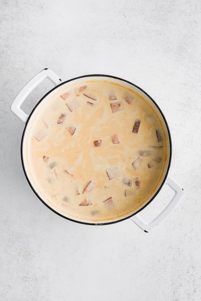 Creamy ham and potato soup in a large soup pot.