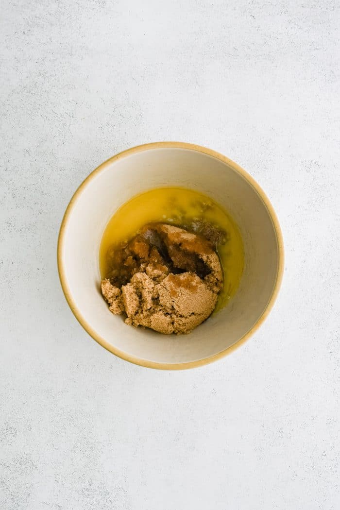 Mixing bowl filled with melted butter and brown sugar.