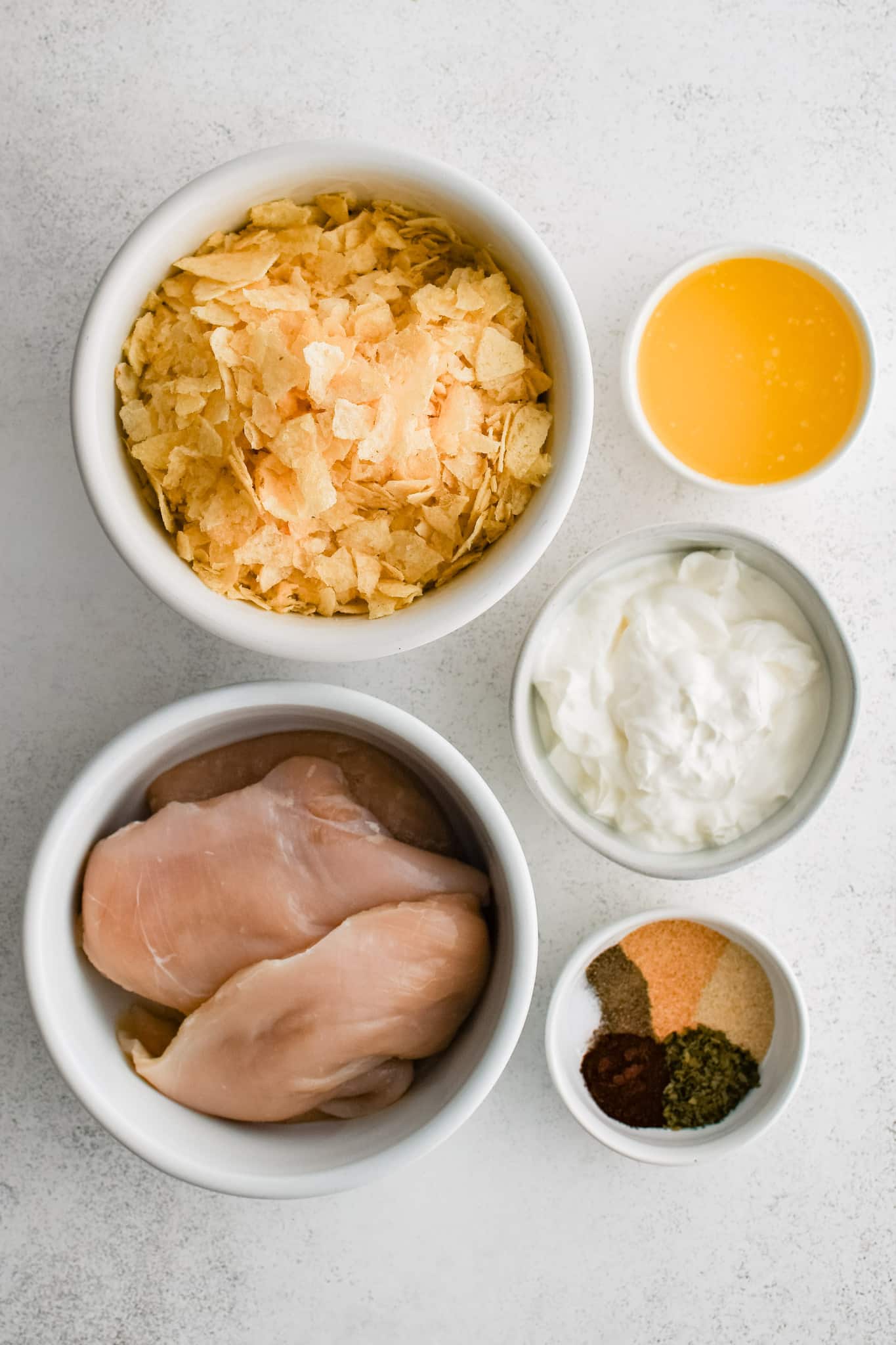 All of the ingredients needed to make potato chip chicken in individual measuring cups and ramekins.