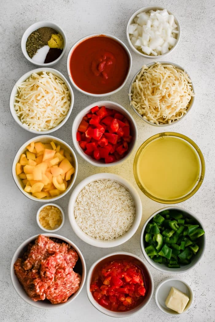 All of the ingredients needed to make Stuffed Pepper Casserole in individual measuring cups and ramekins.