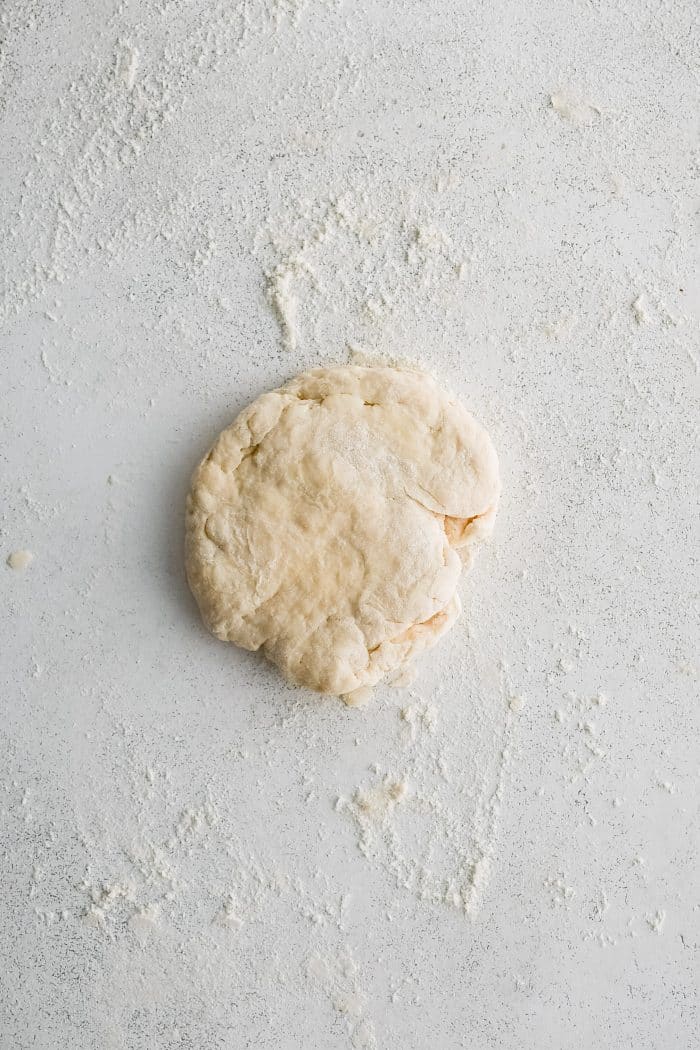 Biscuit dough shaped into a small disc.