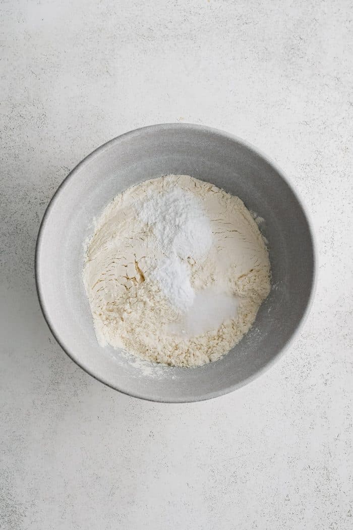 Large bowl with flour, baking powder, baking soda, and salt.