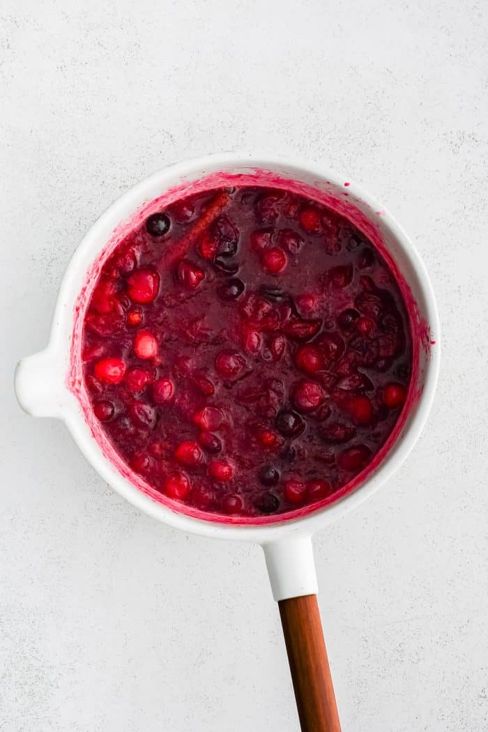 Medium saucepan filled with homemade cranberry sauce made with fresh cranberries.