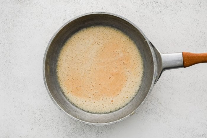 A blonde roux in a large stainless steel skillet.