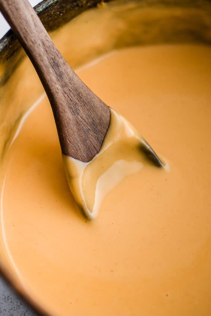 Saucepot filled with silky smooth cheese sauce made from scratch.