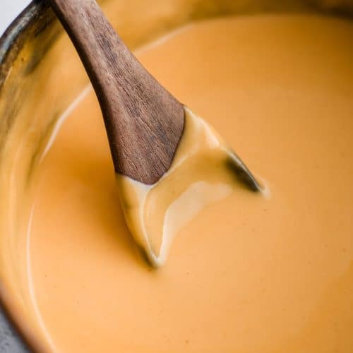 Saucepot filled with silky smooth cheese sauce made from scratch.