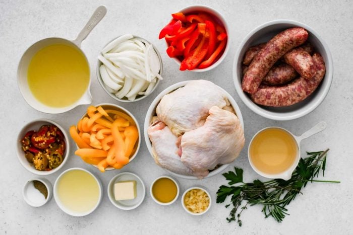 All of the ingredients needed to make Chicken Scarpariello in individual bowls, measuring cups, and ramekins.