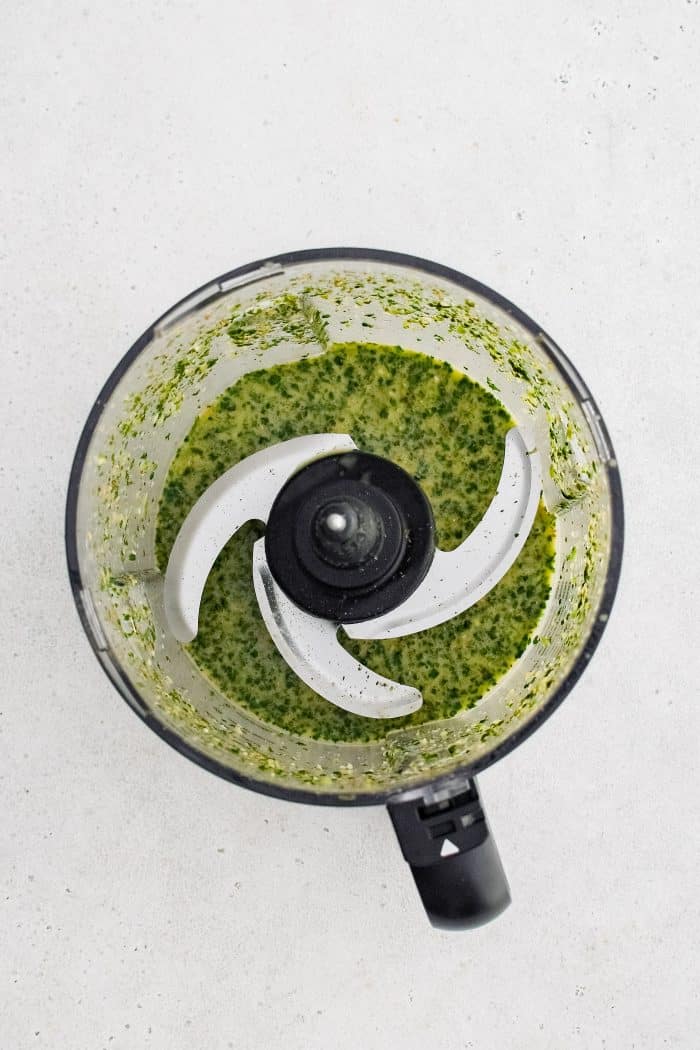 Small food processor filled with blended cilantro lime and garlic marinade.