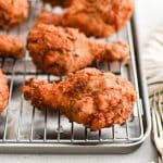 Crispy buttermilk fried chicken cooling on a rack after frying