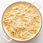 Cook fettuccine pasta and homemade Alfredo sauce in a large skillet.