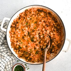 Baked sloppy joe casserole with pasta and topped with melted cheese in a large round casserole dish ready to be served.