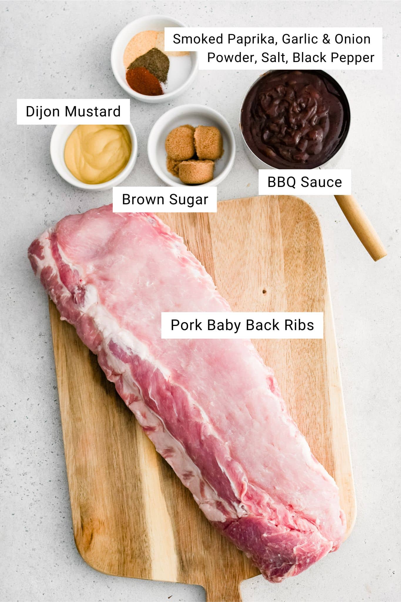 Ingredients for Slow Cooker Baby Back Ribs measured out and set aside in individual serving bowls.