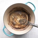 Butter and garlic sizzling in a Dutch oven.