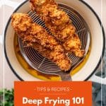 Perfectly golden brown and crispy chicken tenders being lifted from a large pot of sizzling oil in a spider strainer with text overlay reading " Tips and Recipes: Deep Frying 101"
