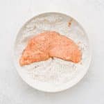 Double-dipping chicken in flour for a second coating.