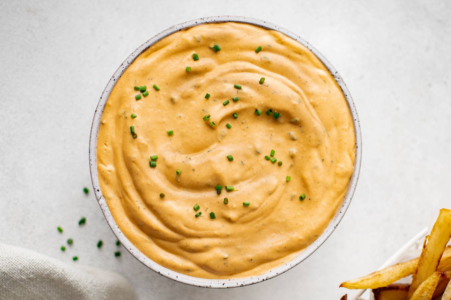 Bowl of finished buffalo ranch sauce topped with chives.