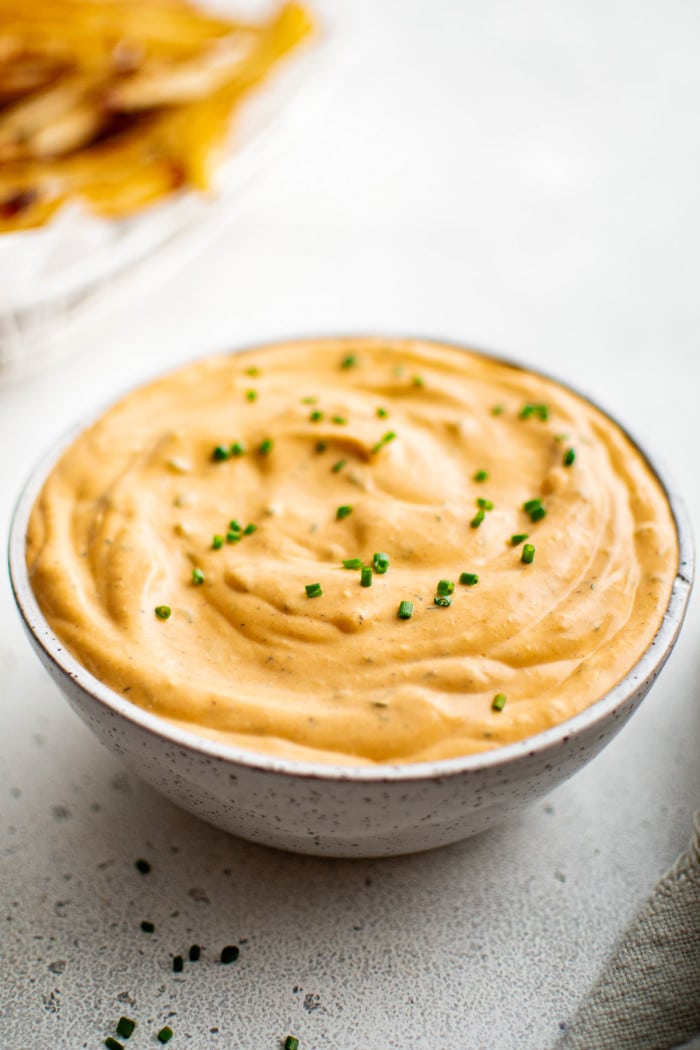 Side view of buffalo ranch sauce in ceramic bowl.