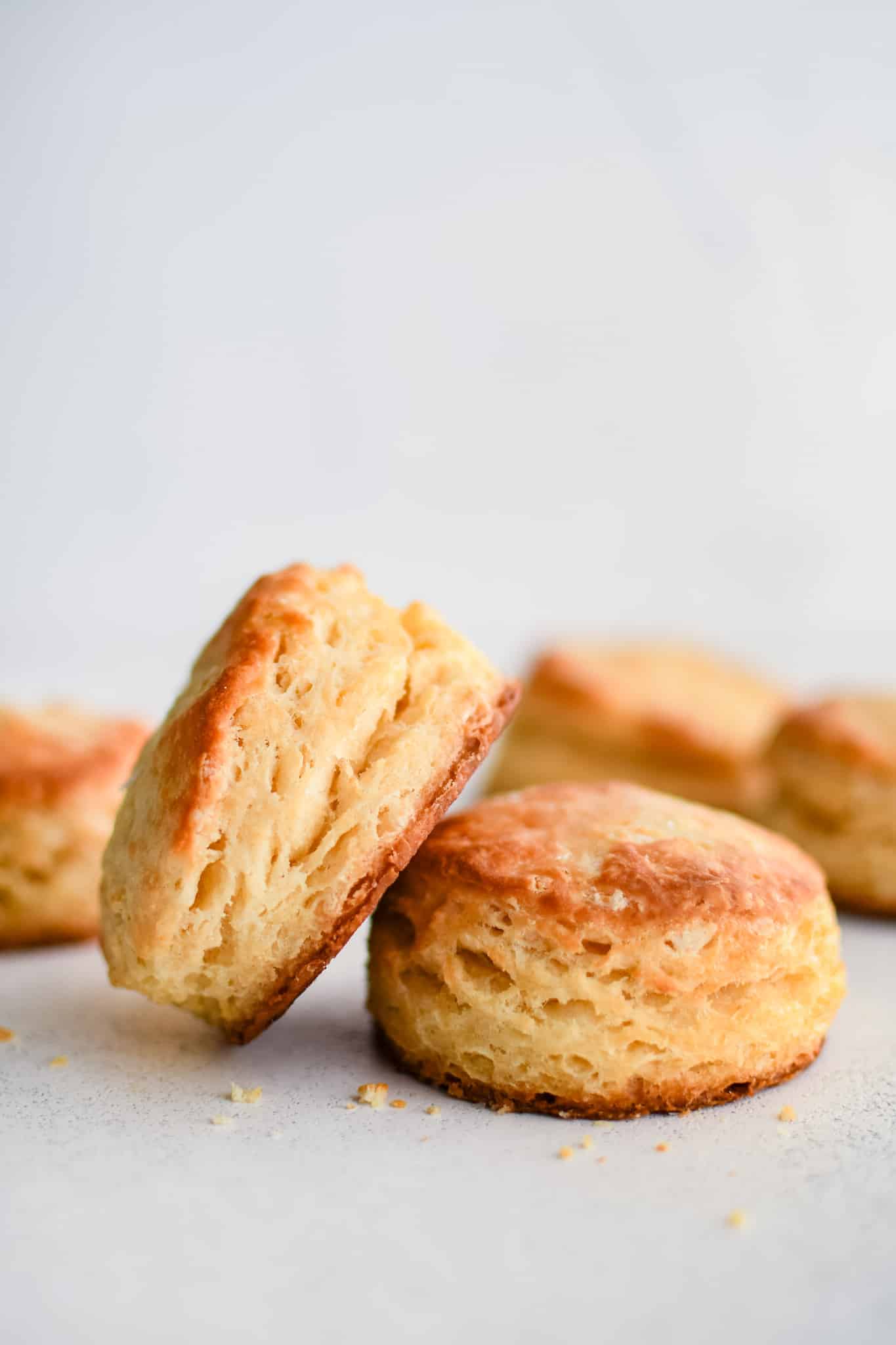 Golden, flaky buttermilk biscuits stacked with visible buttery layers and a tender crumb, perfect for breakfast or serving with gravy
