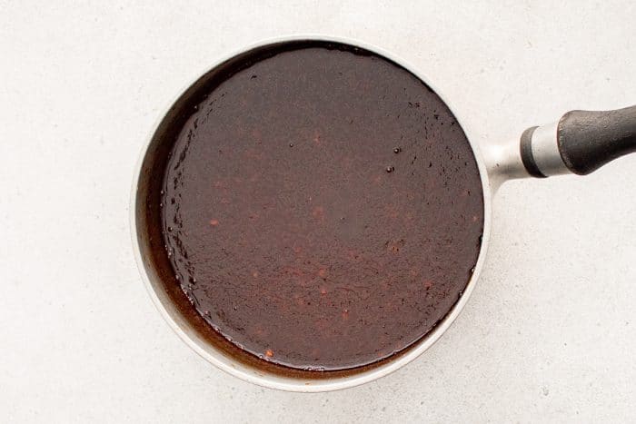 Korean BBQ sauce simmering in a saucepan after combining ingredients