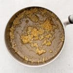 Garlic and ginger sizzling in sesame oil in a saucepan