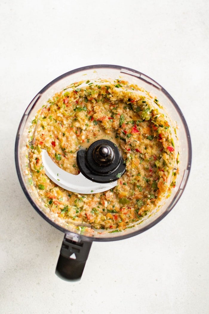 The finished sofrito mixture, a fragrant and colorful blend of herbs, peppers, garlic, and onions, ready to use or freeze.