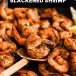 Close-up of blackened shrimp in a skillet with bold white text overlay that reads โBlackened Shrimpโ