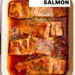 Vertical Pinterest pin featuring a cream-colored baking dish filled with four golden-brown salmon fillets glazed with hot honey, with the text โEasy, 30-Minute Recipe, Hot Honey Salmonโ overlaid in the top right corner.