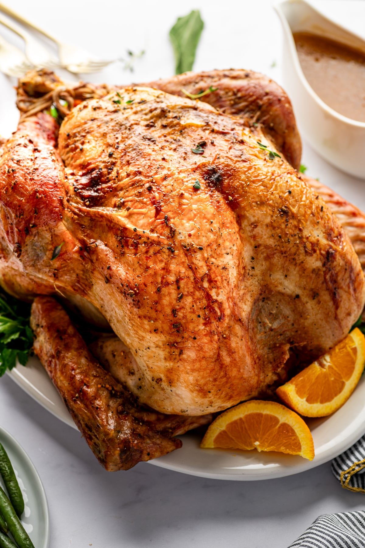 Roasted Thanksgiving turkey served with homemade gravy and fresh orange slices