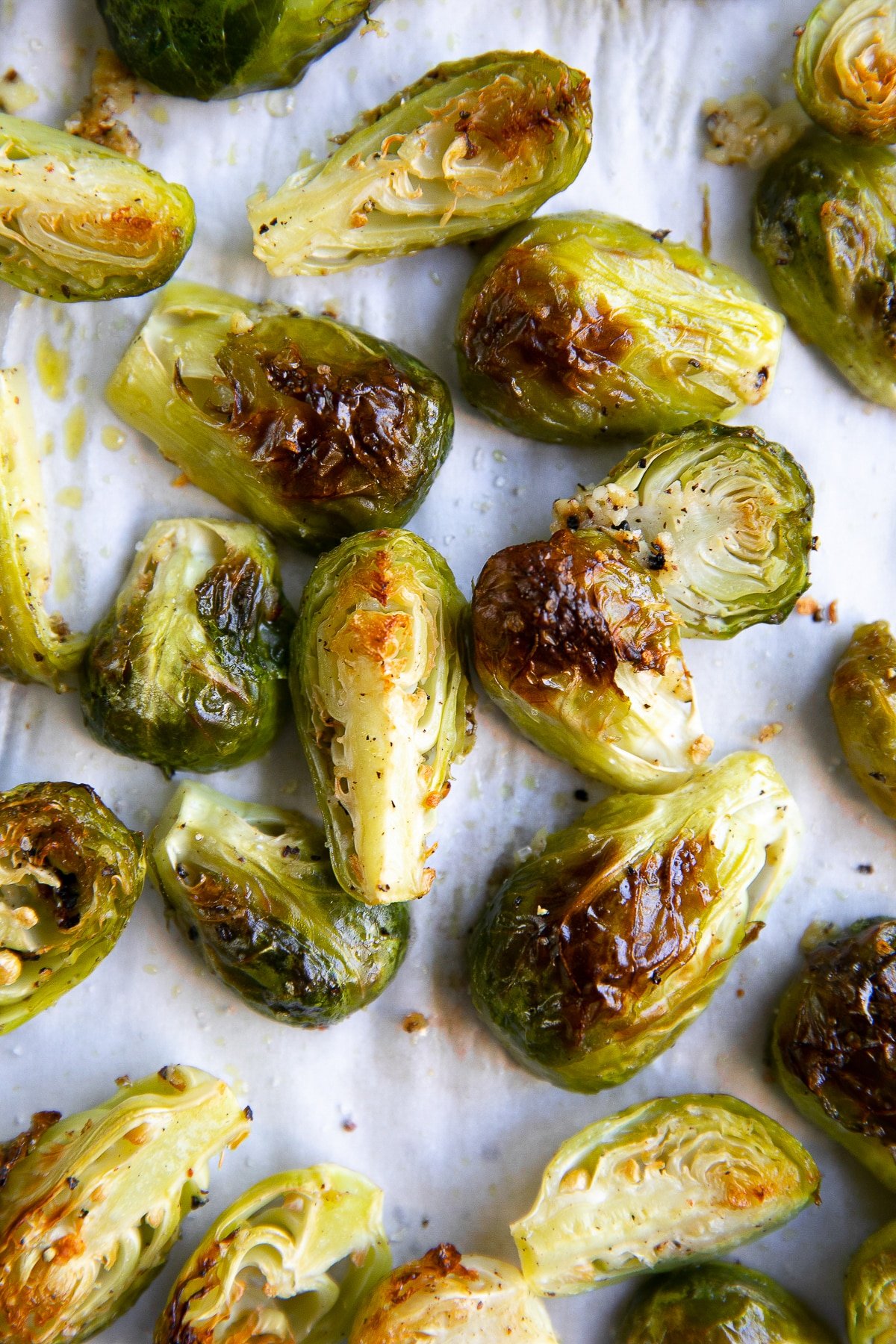 Close-up of crispy roasted Brussels sprouts on a baking sheet.