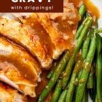 Close-up Pinterest graphic showing juicy sliced turkey with fresh green beans smothered in rich homemade turkey gravy made with pan drippings, styled for Thanksgiving dinner inspiration.