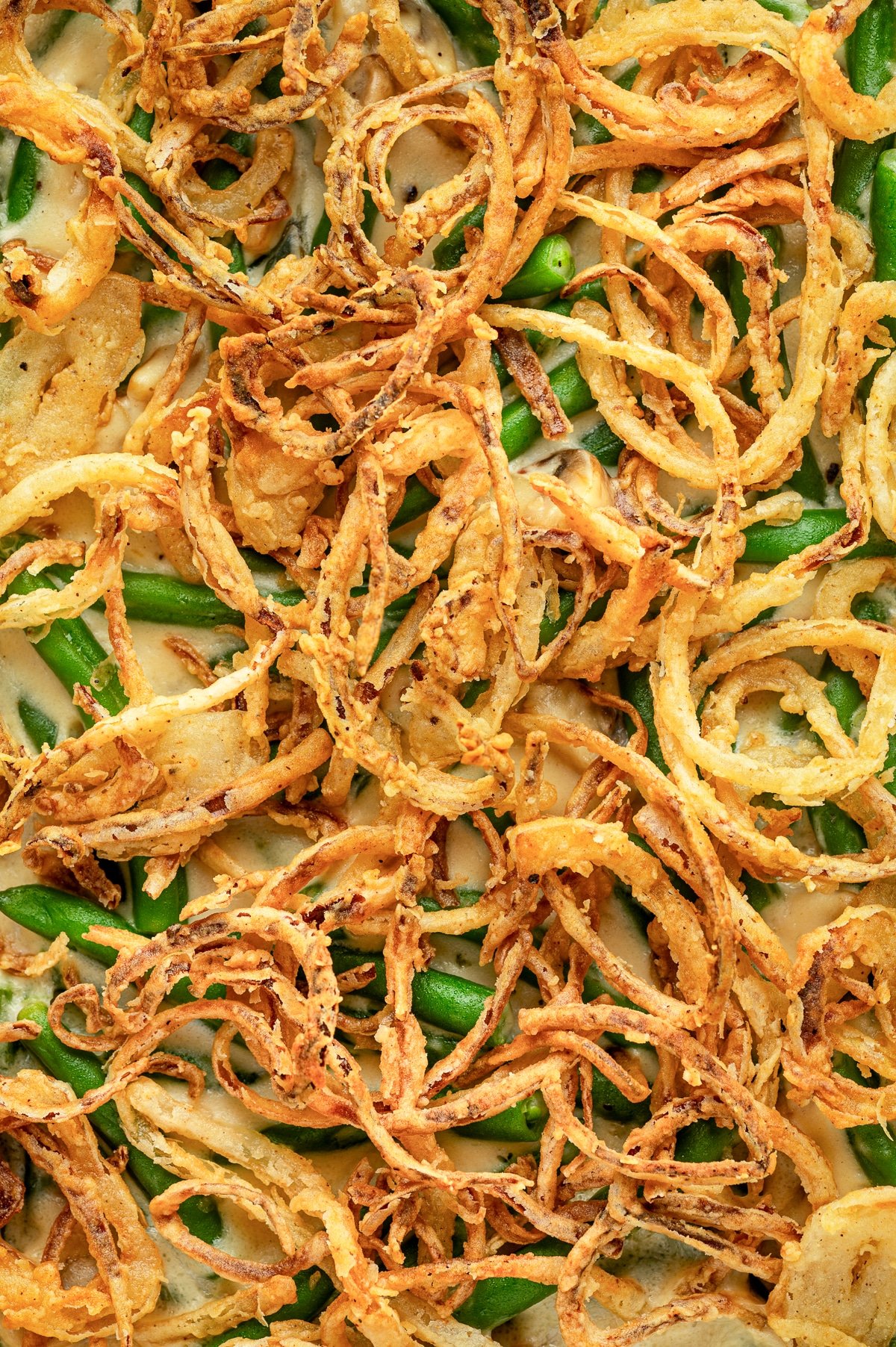 Close-up of crispy fried onions on top of green bean casserole.