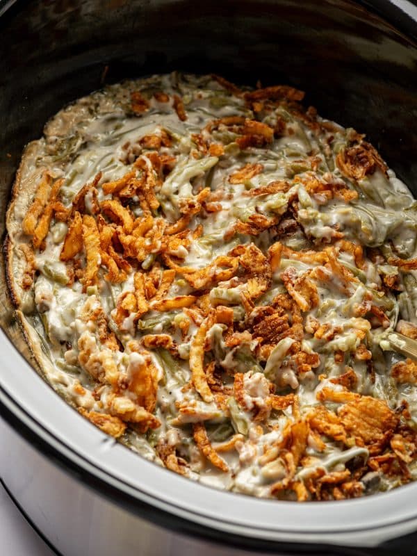 Finished slow cooker green bean casserole topped with crispy onions.