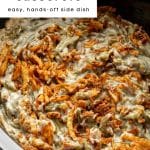Pinterest graphic showing a close-up of slow cooker green bean casserole topped with crispy fried onions, labeled as an easy, hands-off side dish.