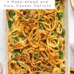 Fresh green bean casserole baked with crispy fried onions, shown in a white baking dish.