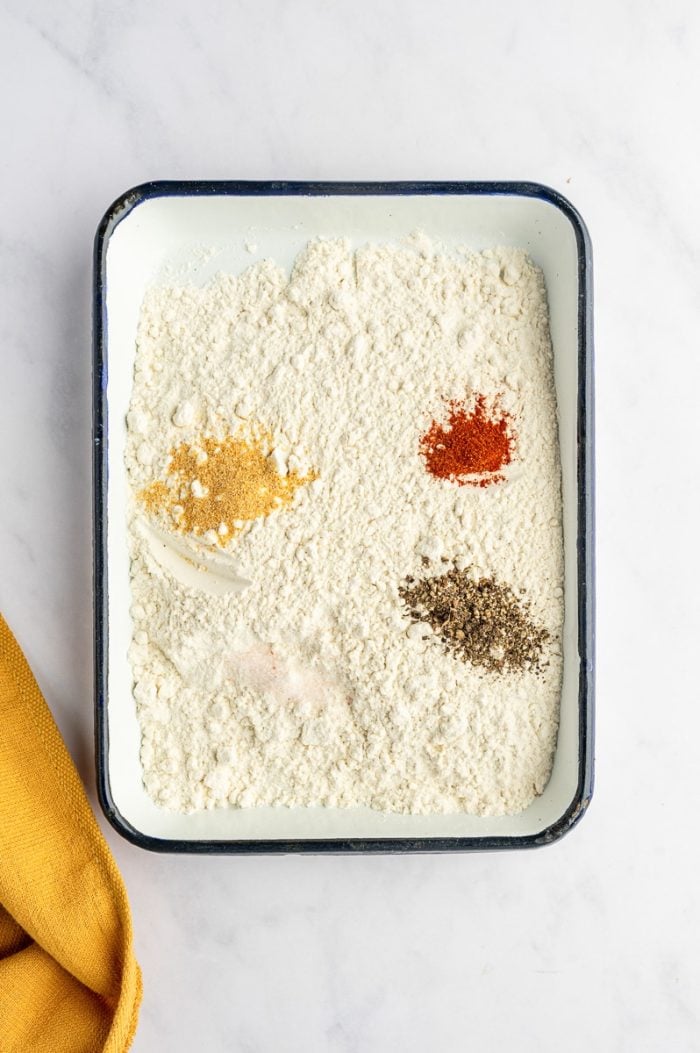 Seasoned flour mixture with paprika, garlic powder, and black pepper.