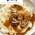 Bowl of mashed potatoes topped with mushroom gravy with text overlay that reads โ30 minute mushroom gravy โ easy, vegetarian recipe.โ
