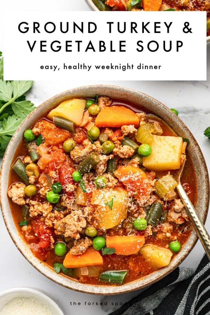 Vertical Pinterest pin with a large white text box across the top reading “GROUND TURKEY & VEGETABLE SOUP” in bold black letters, with smaller black text underneath reading “easy, healthy weeknight dinner.” Below the text box is a close-up of a gray ceramic bowl filled with ground turkey and vegetable soup in a red tomato broth with potato chunks, carrots, green beans, peas, and crumbled turkey, topped with chopped parsley and grated Parmesan. A gold spoon rests in the bowl, with fresh parsley nearby and “theforkedspoon.com” printed near the bottom.