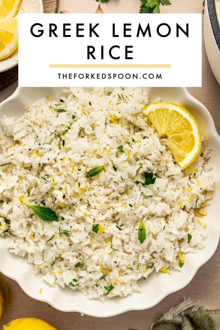 Pinterest pin image showing Greek lemon rice in a white scalloped bowl with lemon slices, fresh herbs, lemon zest, and black pepper. A white text box overlay reads “GREEK LEMON RICE” with “THEFORKEDSPOON.COM” beneath it and a pale yellow underline.