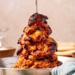 Tender slow-cooked chicken gyro on a vertical spit with crispy charred edges.
