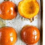 Two halved sugar pumpkins roasted in the oven